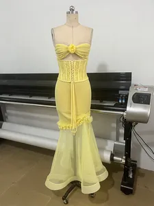 Sexy yellow strapless mermaid gown featuring lace corset waist and ruffled mesh skirt.
