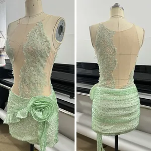Detailed front and back view of a light green sequined hollow dress with flower accent