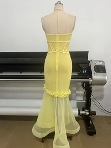 Back view detail of elegant yellow mesh mermaid dress featuring lace waist and ruffled hemline