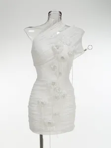 Close-up detail of white mesh halter dress with elegant handmade 3D flower accents