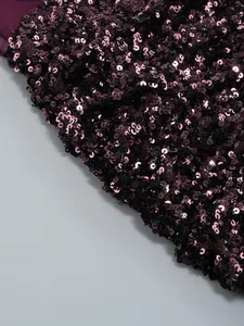 Close-up detail of dark purple shimmering sequins on a luxury evening party dress