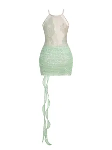 Detailed shot showing texture of mint green sequined lace halter mini dress with ribbons