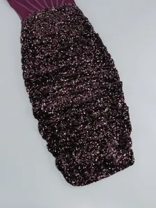 Close-up of elegant purple sequined bodycon party dress showing glitter fabric texture