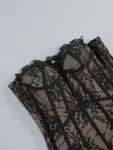 Close-up detail of black floral lace corset bodice with boning and eyelash lace trim.