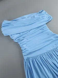 Close-up detail of a light blue off-shoulder pleated dress with elegant ruched texture
