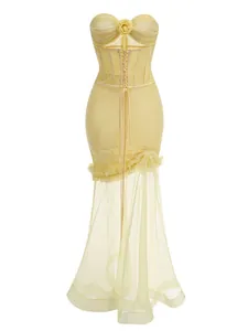 Detailed view of the yellow strapless corset gown with mesh ruffles and 3D flower.