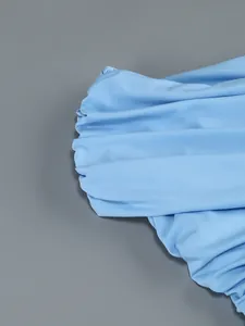 Detailed close-up of light blue pleated fabric on elegant sexy one-shoulder dress