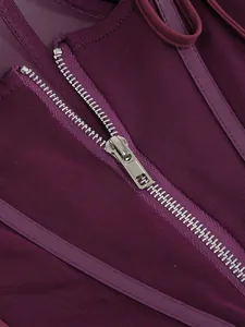 Close-up of the silver metal zipper and purple mesh fabric texture on this elegant dress.