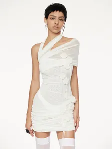 Close-up of white mesh halter dress with floral details and off-the-shoulder design