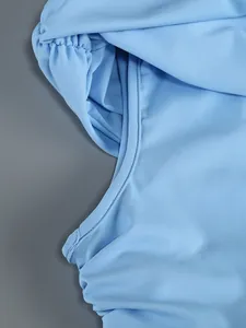 Detailed close-up of fine stitching and pleated fabric on this light blue one-shoulder dress