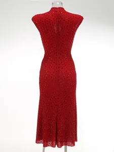Close-up back view of a red evening dress with sparkling rhinestones and mesh texture