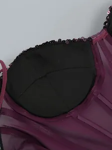 Detailed macro shot of a sequined dress interior with padded cups and mesh fabric.