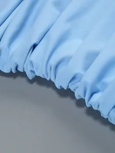 Macro shot of ruched texture detail on light blue slim fit elegant women's dress