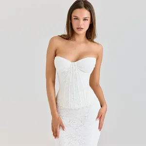 Close-up detail of an elegant white lace corset gown with intricate floral patterns