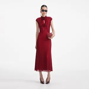 Full view of elegant red rhinestone maxi dress with floral accents on a fashion model