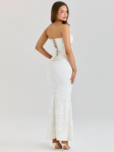Close-up detail of white lace evening dress with elegant lace-up corset back design
