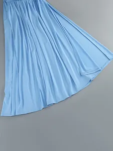 Detailed macro view showing the light blue pleated fabric on an elegant maxi dress