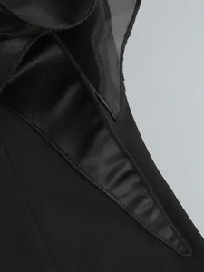 Close-up detail of the black satin fabric and premium stitching on a floral gown