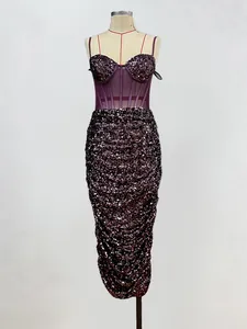 Detailed view of an elegant burgundy sequin bodycon dress with mesh corset top.