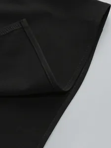 Close-up detail of the fine stitching and black fabric texture on an evening dress.