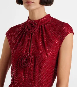Close-up of red rhinestone dress with elegant 3D floral and keyhole detail