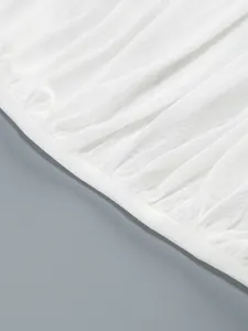 Detailed macro view of white mesh fabric texture and pleated hem of sexy bodycon dress