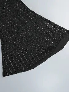Détail en gros plan des paillettes noires sur le tissu d'une robe de soirée chic