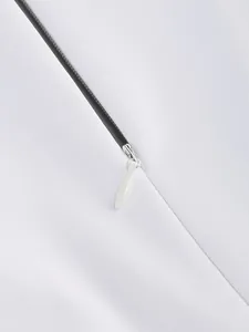 Detail shot of hidden white zipper on a premium long-sleeved formal evening dress for women.