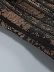 Close-up of exquisite black floral lace and mesh lining detail on a sexy corset bodice