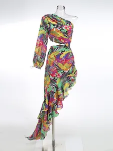 Detail view of vibrant tropical print one-shoulder maxi dress with ruffled hemline