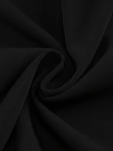 Close-up view of the premium black woven fabric texture for an elegant evening party dress