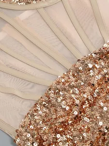 Close-up detail of shimmering gold sequins and mesh fabric on a sexy party dress
