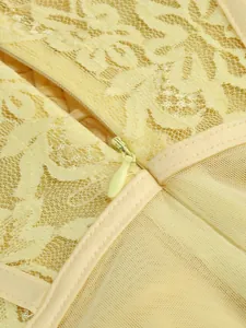 Macro view of matching hidden zipper on yellow floral lace and mesh evening gown