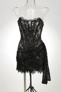 Sexy black lace strapless corset mini dress featuring sheer panels and side drape detail
