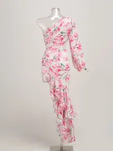 Detailed view of an elegant white floral dress with one-shoulder design and ruffles.