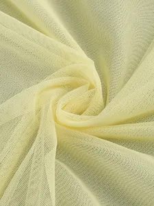 Close-up of pale yellow sheer mesh fabric with fine net texture and elegant drape
