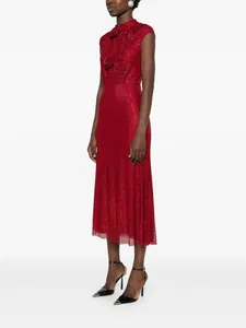 Side view of elegant red sleeveless evening dress with rhinestones and floral accents