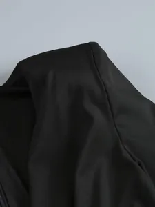 Close-up of high-quality black fabric texture on long-sleeved formal dress