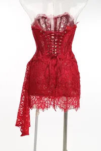 Close-up of red lace corset dress back with elegant lacing and trailing lace