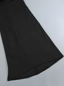 Detail shot of black long dress hemline showing high-quality fabric and clean stitching.