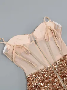 Detailed back view of a sequin corset dress with mesh panels and gold zipper