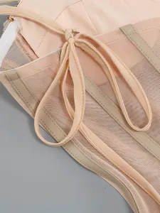 Close-up view of mesh fabric and structured boning details on a nude party dress