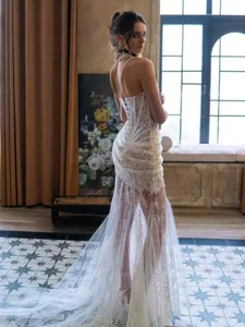 Detailed view of white lace sheer corset maxi dress with elegant floor-length train