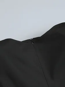 Detailed close-up showing the high-quality invisible zipper on this elegant black dress
