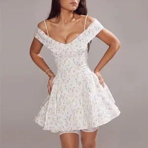 Detail view of a floral off-shoulder mini dress with ruffled skirt and thin straps