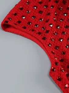Detailed macro shot of red mesh fabric with square rhinestone studs on a formal dress