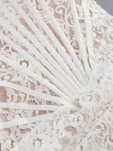 Close-up of intricate white lace detail with structural corset boning ribbons