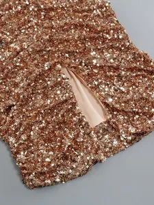 Close-up detail showing the sparkling rose gold sequins of an elegant evening dress gown