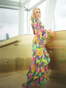 Side view of vibrant floral and zebra print ruffle dress with one-shoulder detail