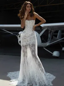 Detail view of a white lace strapless corset maxi dress with sheer lace skirt